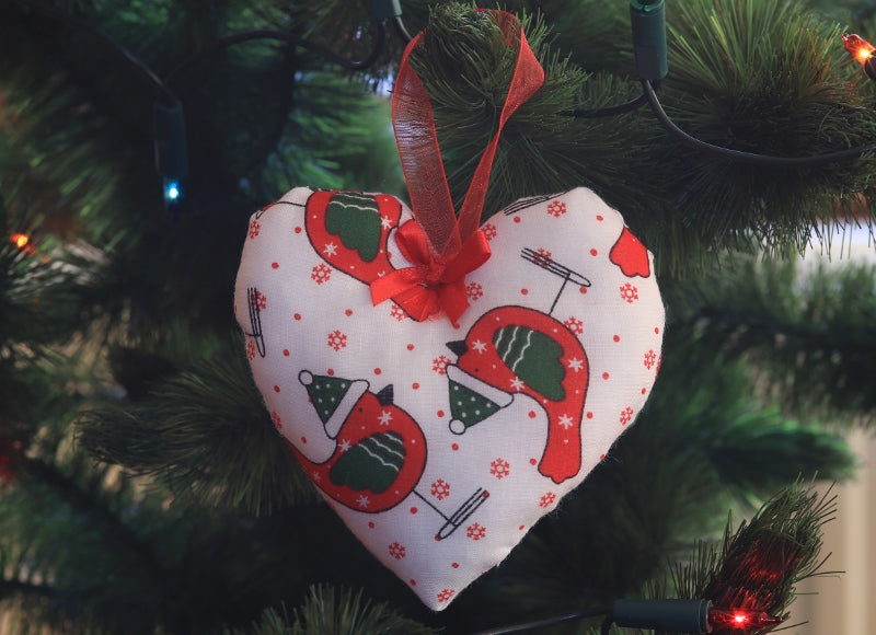 Handmade Christmas tree ornaments from Sable Homeware featuring festive holiday designs on a decorated Christmas tree.