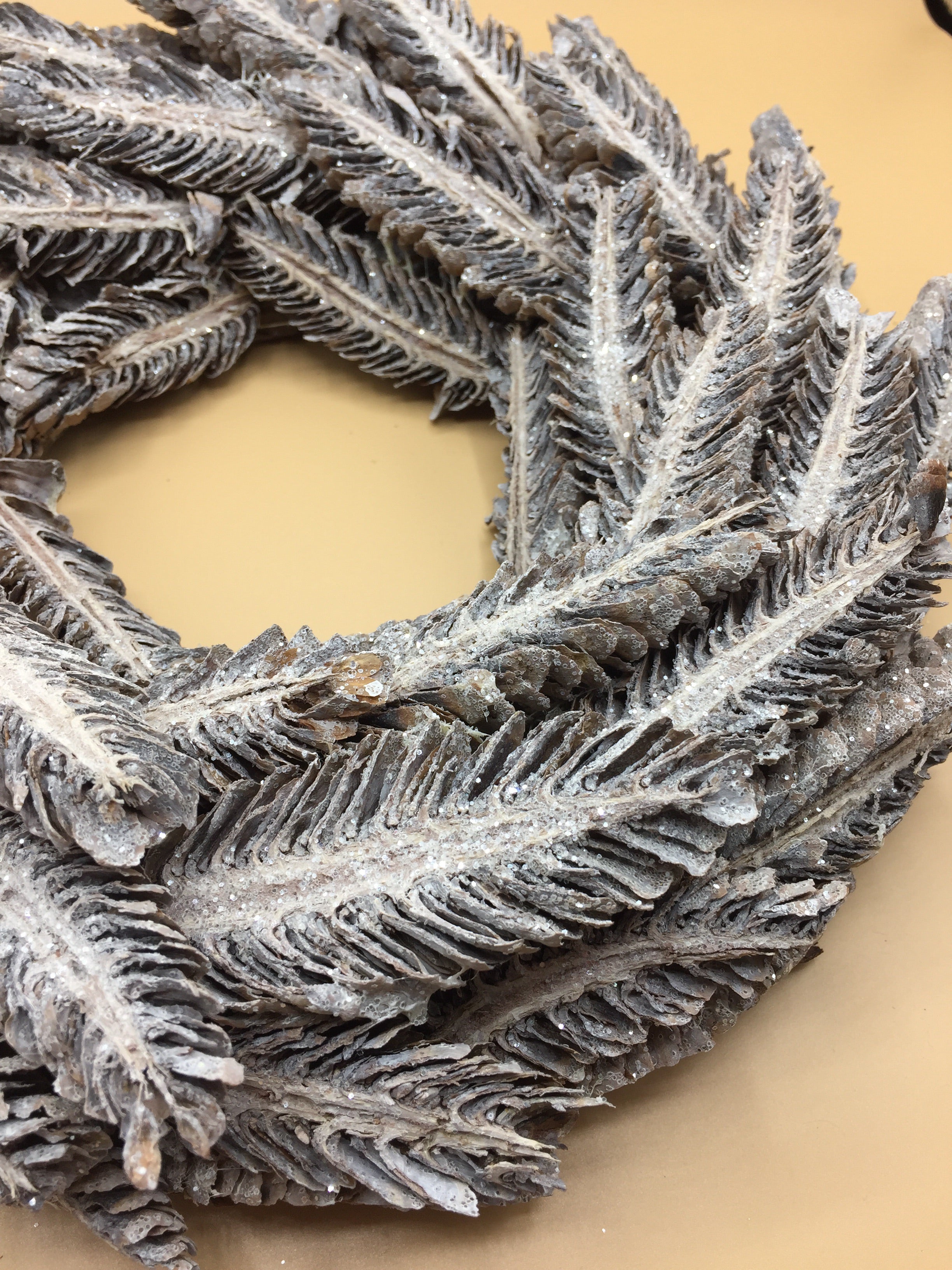 Round silver and grey glittery wreath with festive design, perfect for holiday or home decor by Sable Homeware.