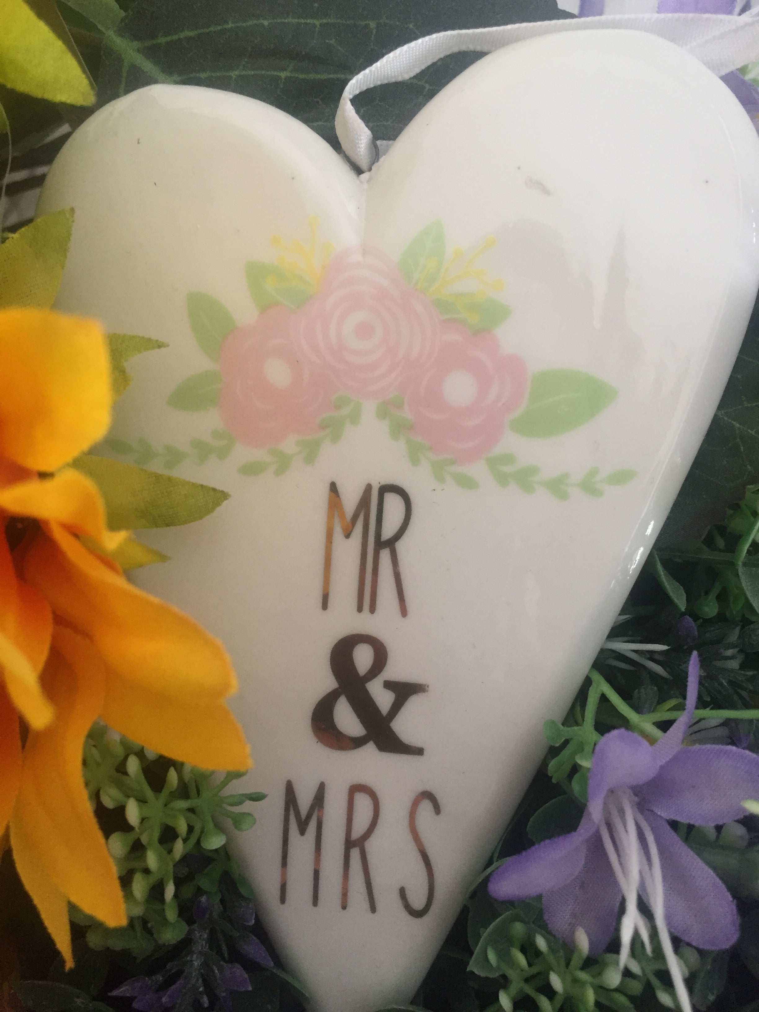 Ceramic Mr & Mrs Heart by Sable Homeware shown hanging on a wall, classic wedding keepsake decoration.