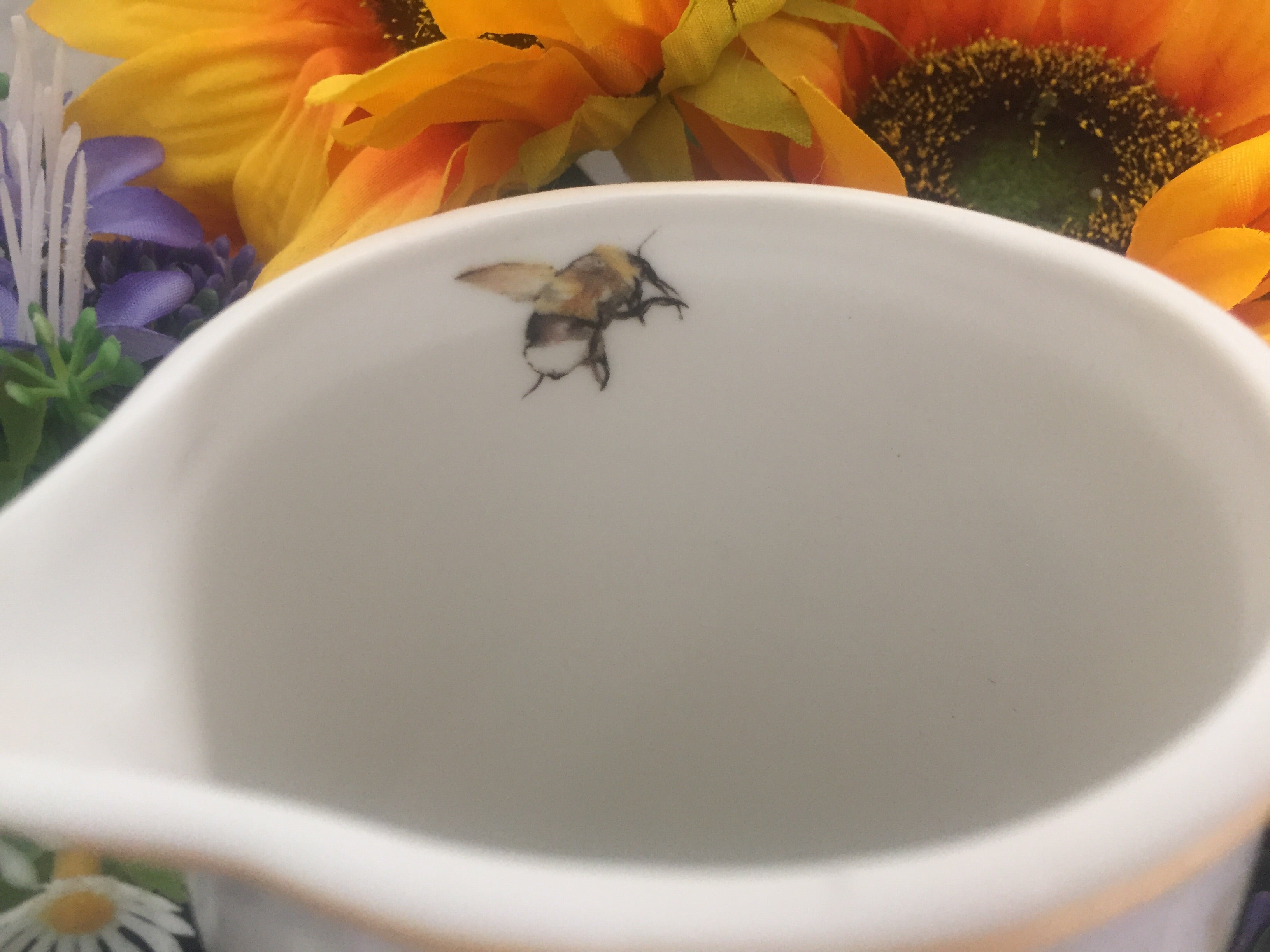 Small Busy Bees jug by Sable Homeware, featuring colorful bee and floral designs, made of ceramic, ideal for serving beverages.