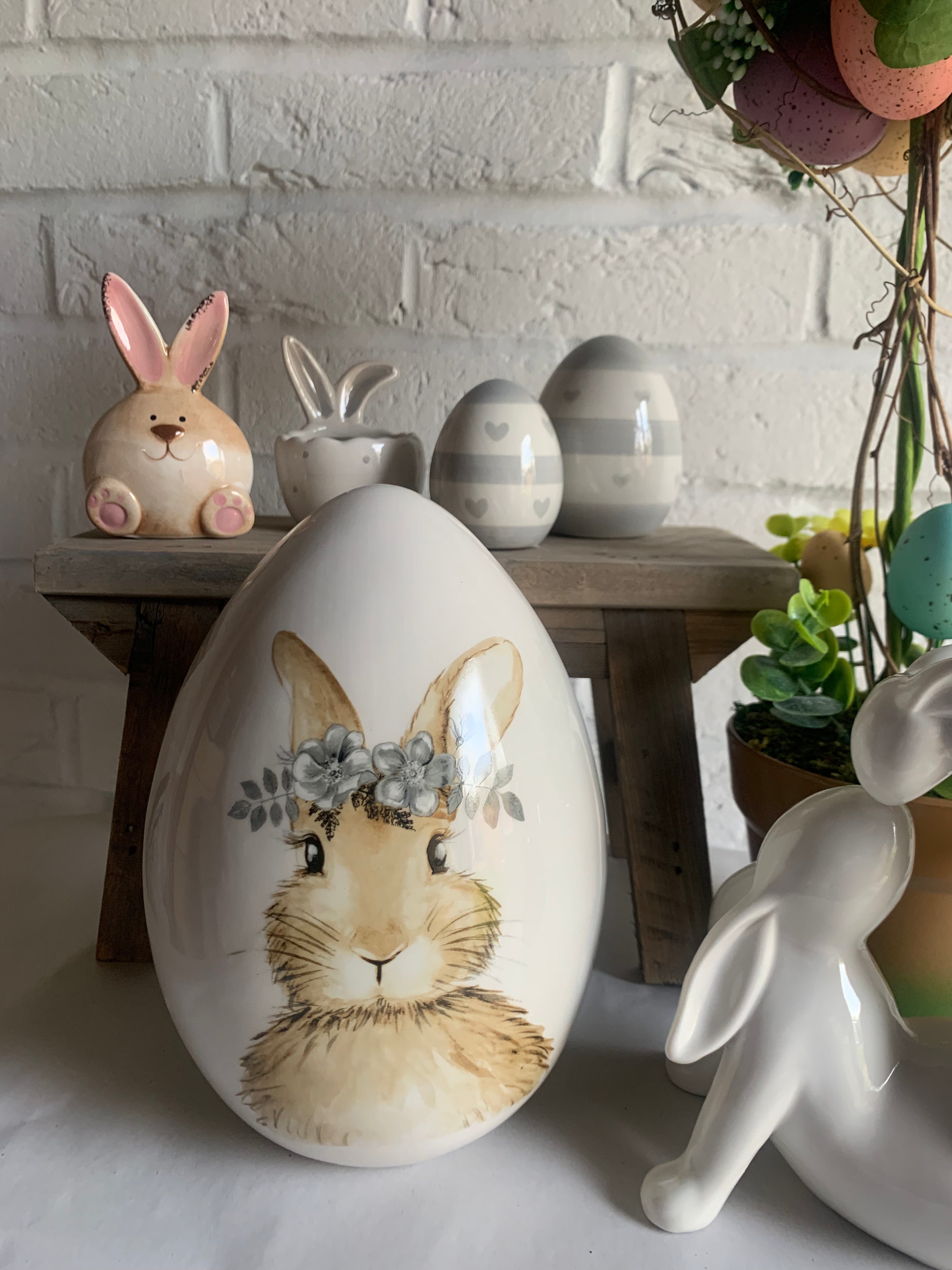 Sable Homeware Spring Bunny Collection home decor with decorative bunny figurines in pastel colors on a wooden surface.