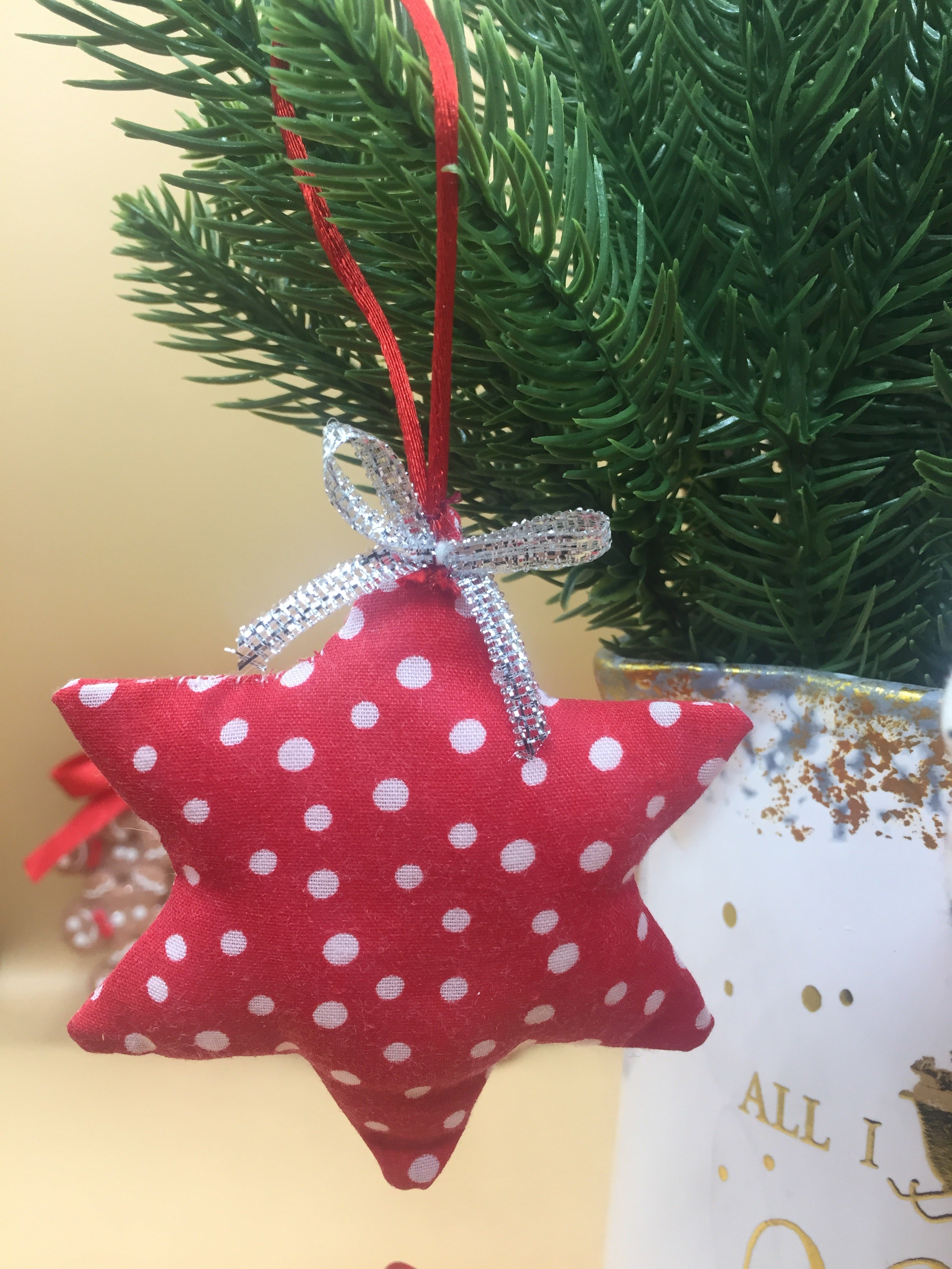 Handmade Christmas tree ornaments from Sable Homeware, featuring colorful festive decorations on a decorated Christmas tree.
