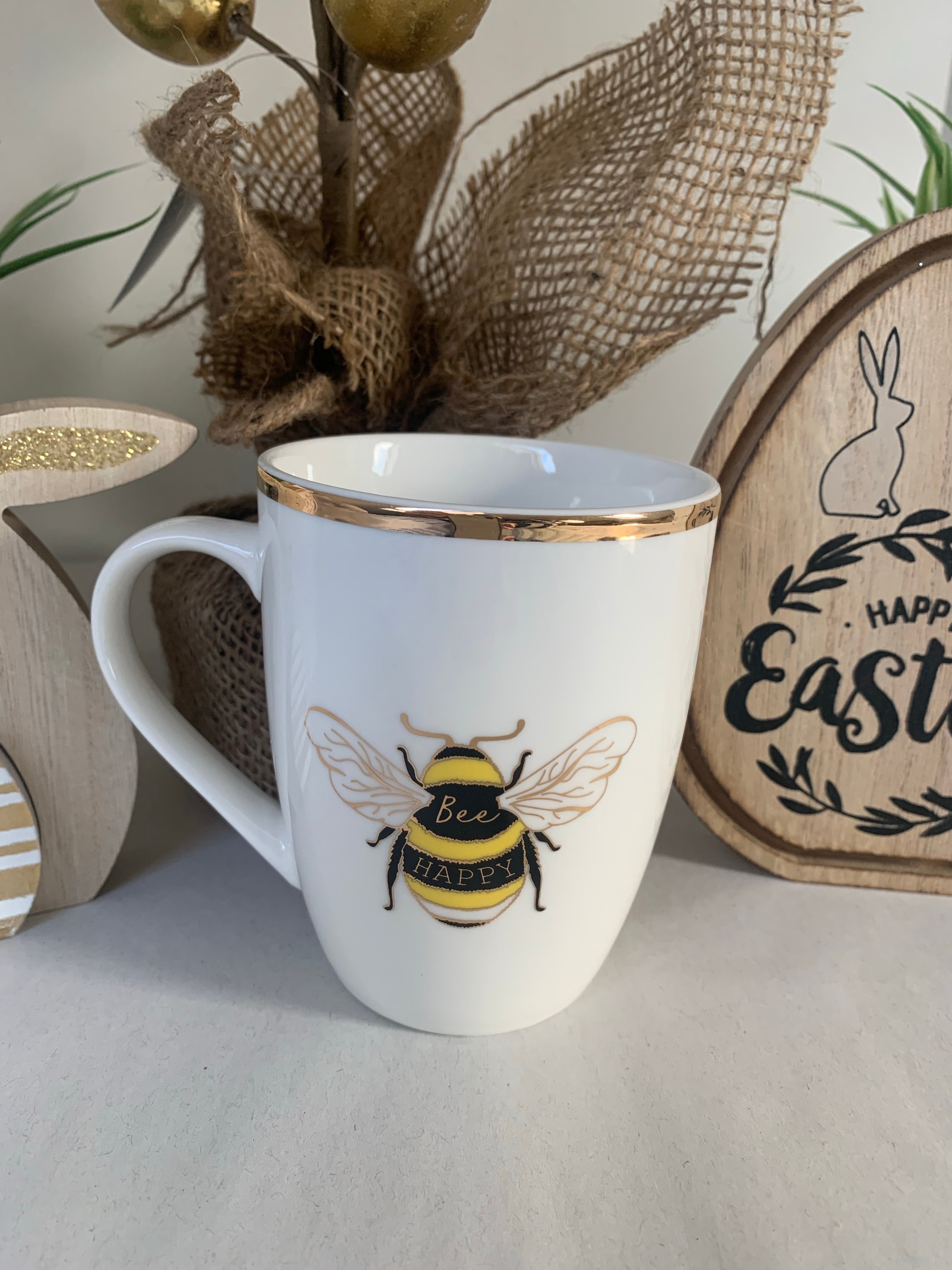 White and gold ceramic mug from Sable Homeware's Bee Happy collection, featuring a cheerful bee design.