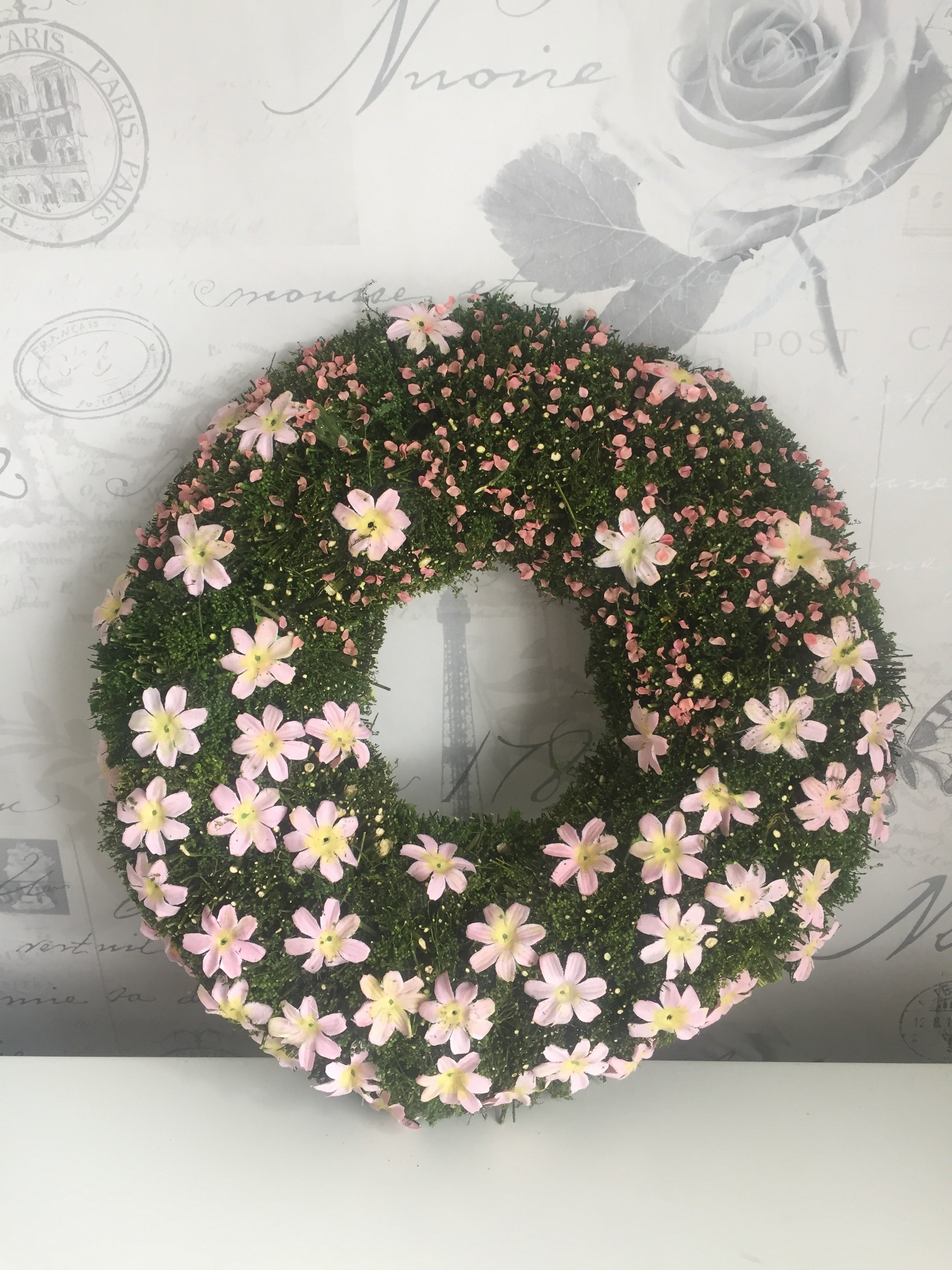 Sable Homeware Easter Floral Mossy Wreath hung on an interior wall